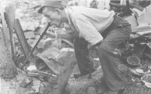 Survivor of U.S. Bombing in Tokyo Tries to Drink from Water Pipe